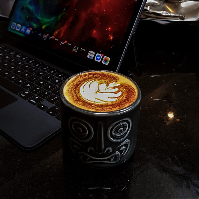 latte art tiki mug in front of ipad